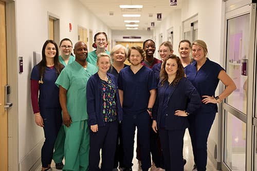 A diverse group of staff smiling